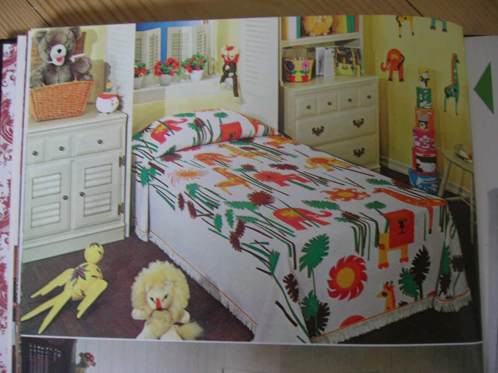 A boldly-patterned and colored bedspread provides the major color scheme for delightful child's room.